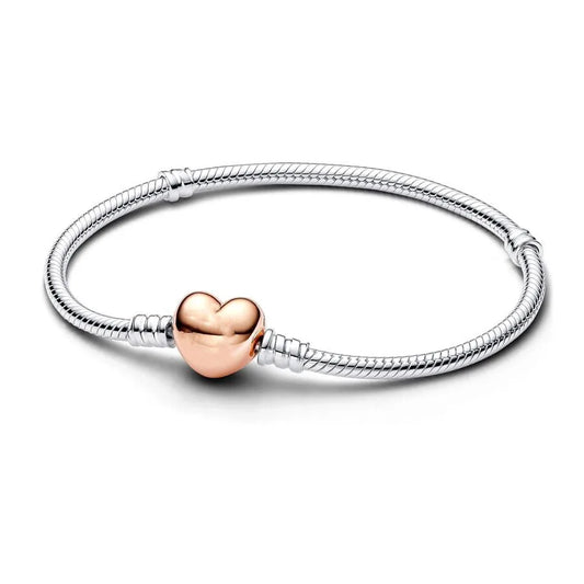 Silver bracelet with a rose gold heart charm on a white background
