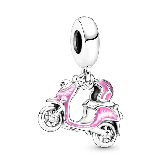 moped Motorcycle-shaped charm with pink details on a white background