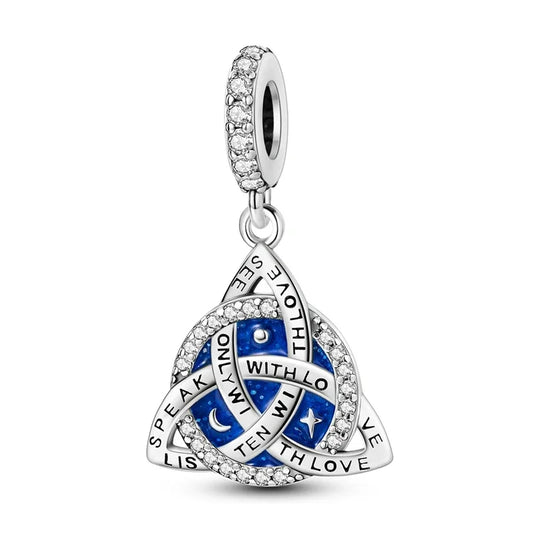 Silver pendant with blue accents and engraved text on a white background