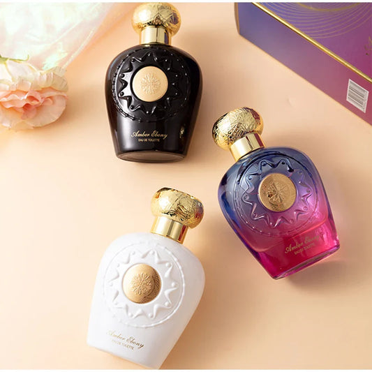 Three perfume bottles with gold caps on a beige background
