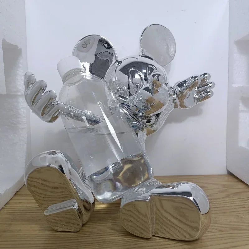 Clear and silver decorative figure on a wooden surface with a white background