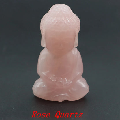 Rose Quartz Buddha figurine on a dark background