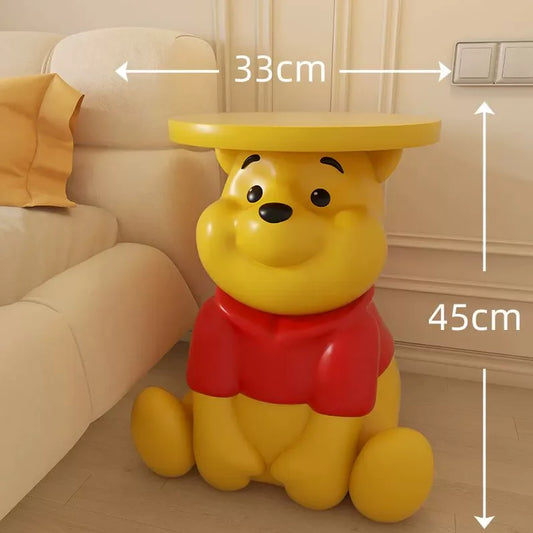 Whinnie the Pooh Yellow bear-shaped side table with dimensions labeled in a room setting.
