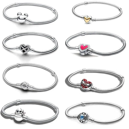 Collection of silver bracelets with various charms on a white background