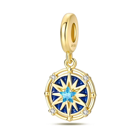 Gold pendant with blue gemstone on a white background