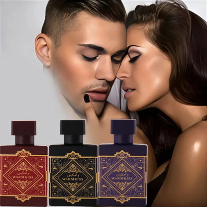 Two people close together with three perfume bottles in front of them.