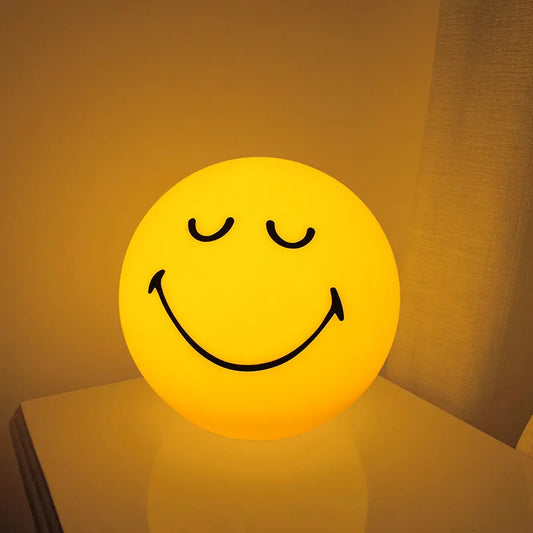 Smiley face light emitting a warm glow on a surface with a soft brown background