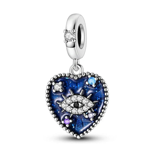 Heart-shaped charm with eye design and blue enamel on a white background