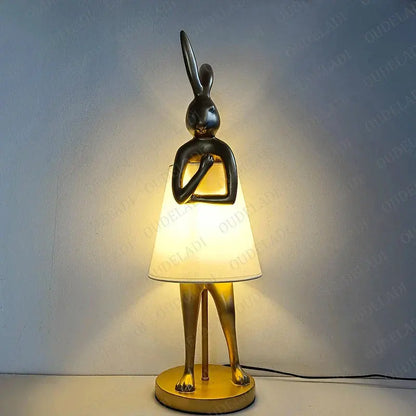 Decorative table lamp with rabbit design on a plain background