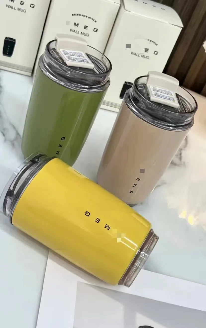 SMEG Three cylindrical containers with 'SMEG' branding on a white surface.