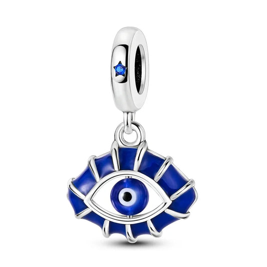 Silver charm with blue eye design on a white background