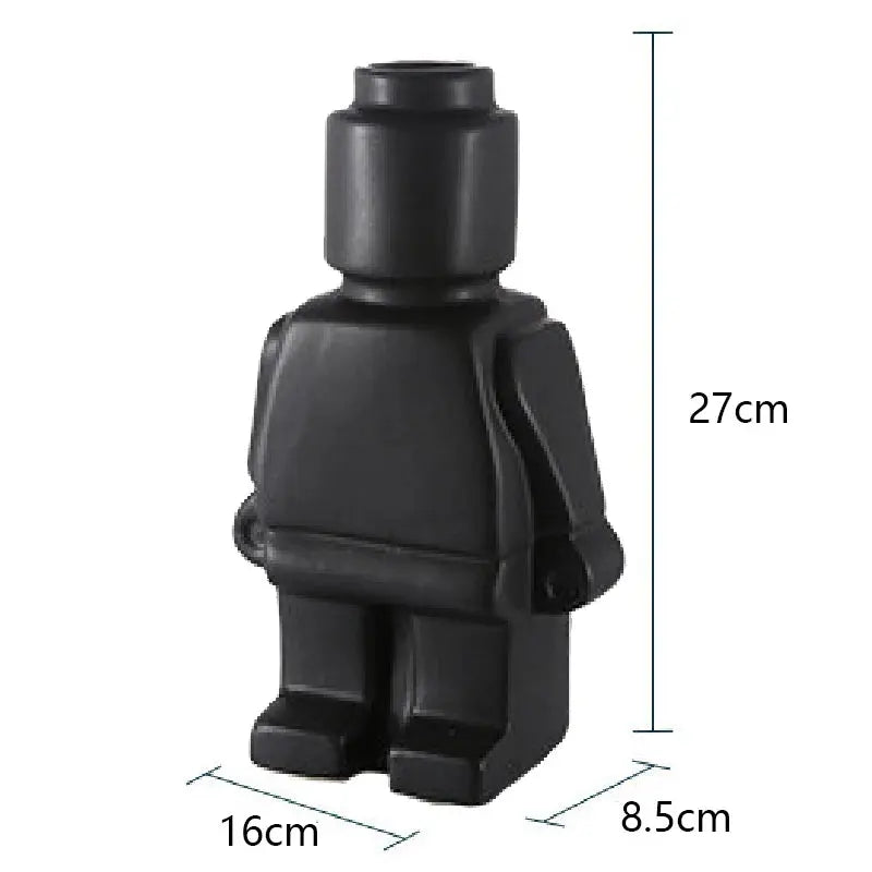 Two Lego Man Vases, one black and one white, designed to look like figures with a decorative plant in each.