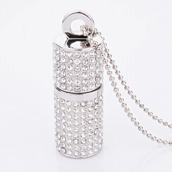 Silver lip balm-shaped pendant with rhinestones on a white background