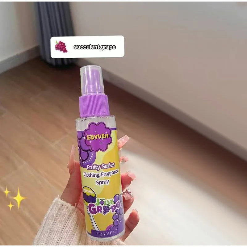 Hand holding a 'Jolly Grape' spray bottle with a purple cap and yellow label.