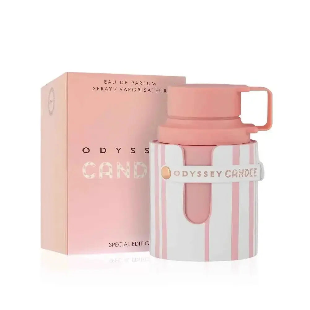 Pink and white perfume bottle with matching box labeled 'Odyssey Candee' on a white background