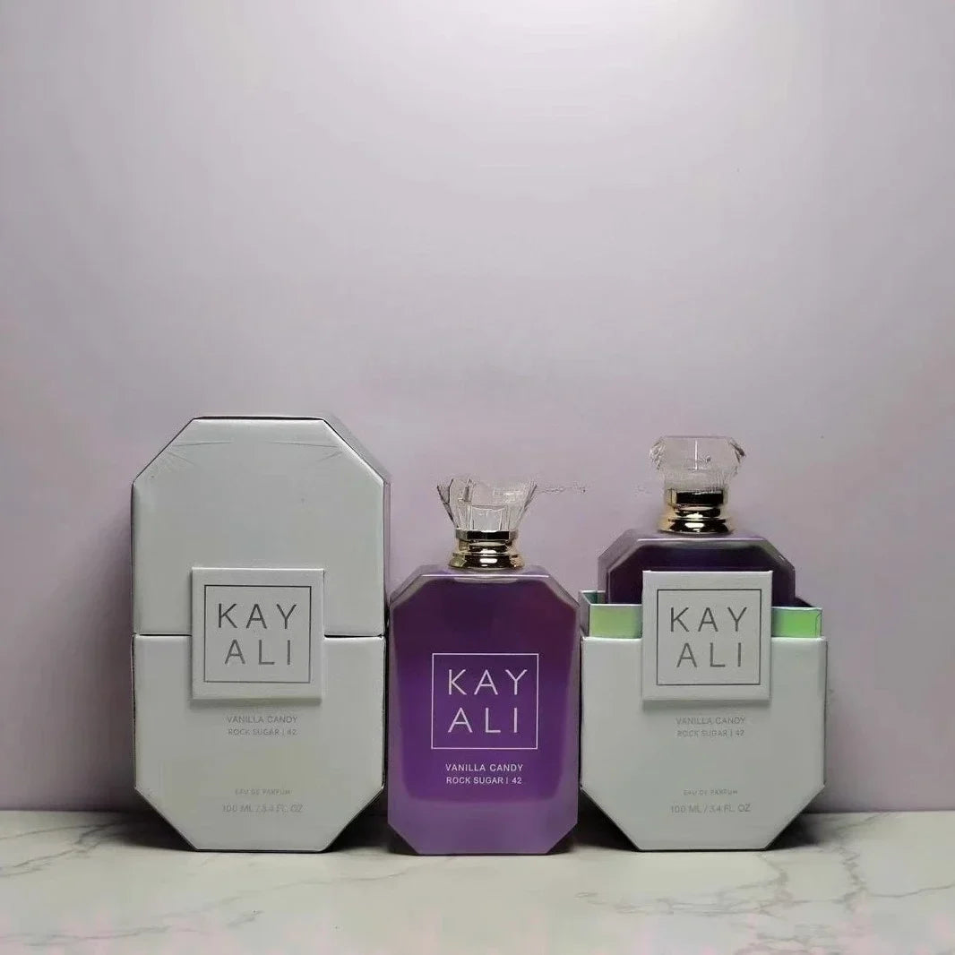 Two bottles and their packaging of 'KAY ALI' on a light purple background