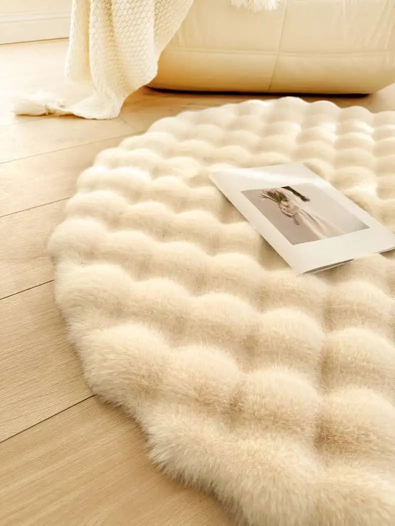 Round beige fur rug on a wooden floor with a photo frame on top