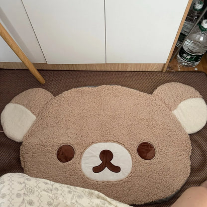Bear-shaped rug on a floor with a white cabinet and bottles in the background