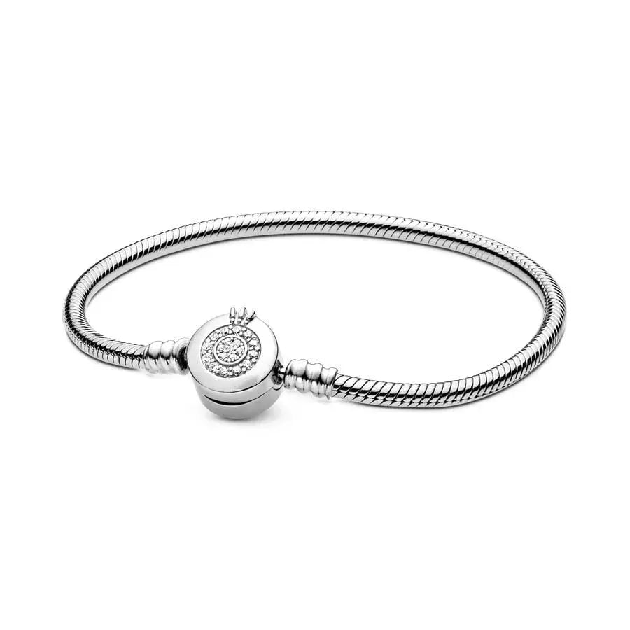 Silver bracelet with a round charm on a white background