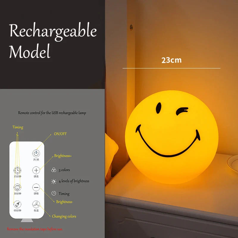 Smiley face night light with remote control on a shelf, labeled as rechargeable model.