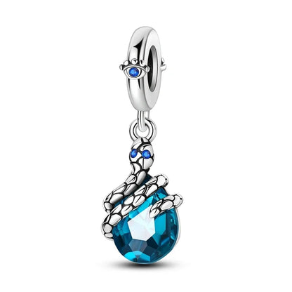 Jewelry charm with blue teardrop and silver accents on a white background
