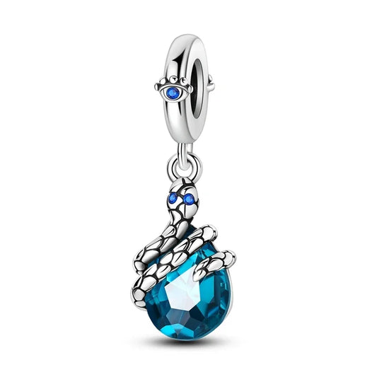 Jewelry charm with blue teardrop and silver accents on a white background
