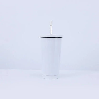 White tumbler with a black rim and silver straw on a light purple background