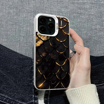 Hand holding a phone with a black and gold patterned case against a gray background
