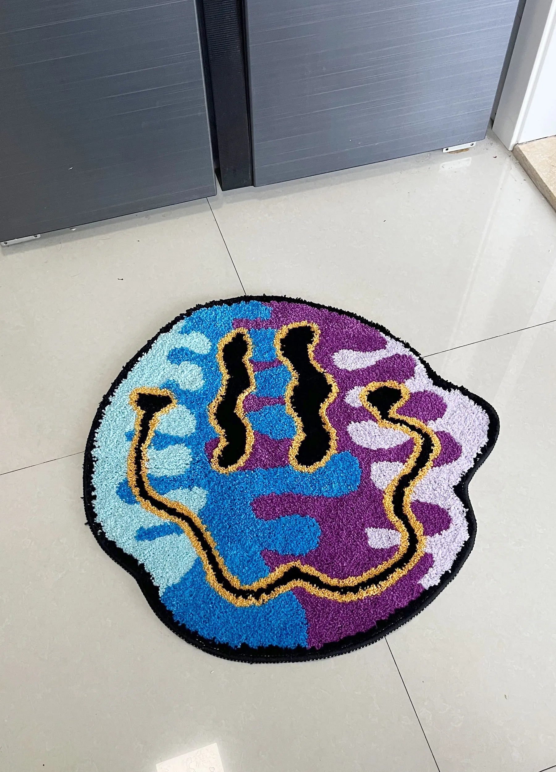 Colorful doormat with abstract design on a tiled floor