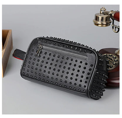 Black studded clutch bag on a light gray background with a vintage phone and wooden box.