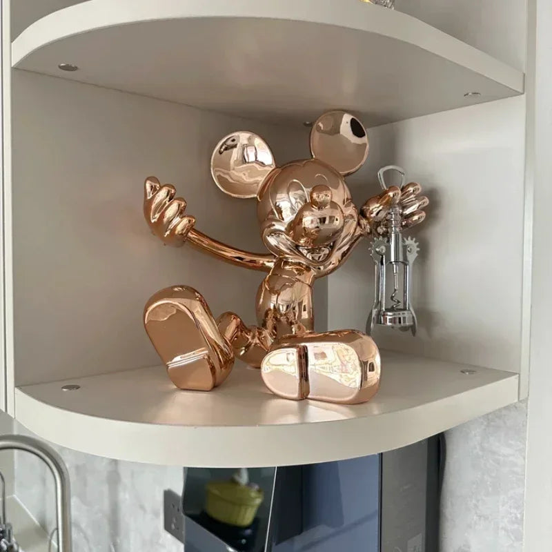 Rose gold Mickey Mouse sculpture on a shelf
