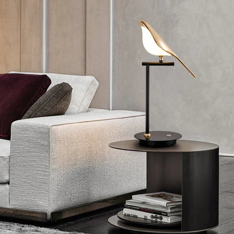 Modern living room with a gray sofa, black side table, and decorative lamp.