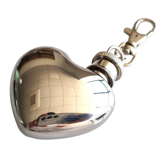 Shiny metal flask with keychain on a white background