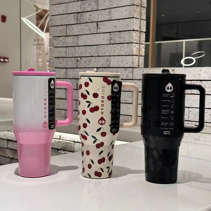 HydroJug Gobelet 40OZ Voyageur Thermos in pink, cherry print, and black variants, highlighting stylish and functional drinkware options.