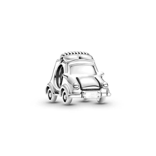 Silver car-shaped charm on a white background