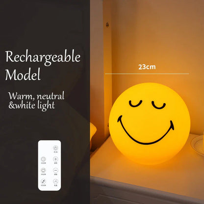 Smiley face night light with rechargeable model and control panel on a dark background