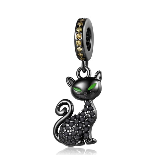 Black cat charm with green eyes on a white background