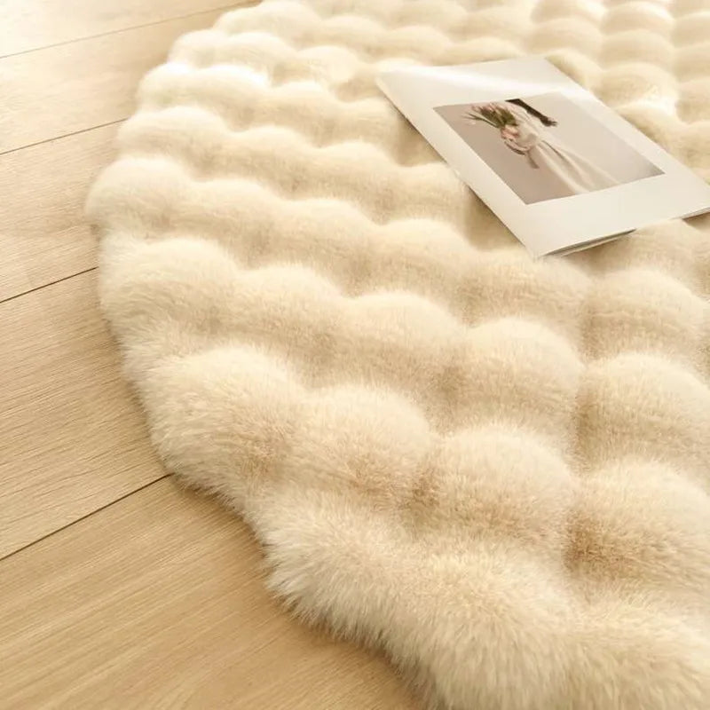 Beige fluffy rug on a wooden floor with a photo album on top