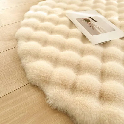 Beige fluffy rug on a wooden floor with a photo album on top