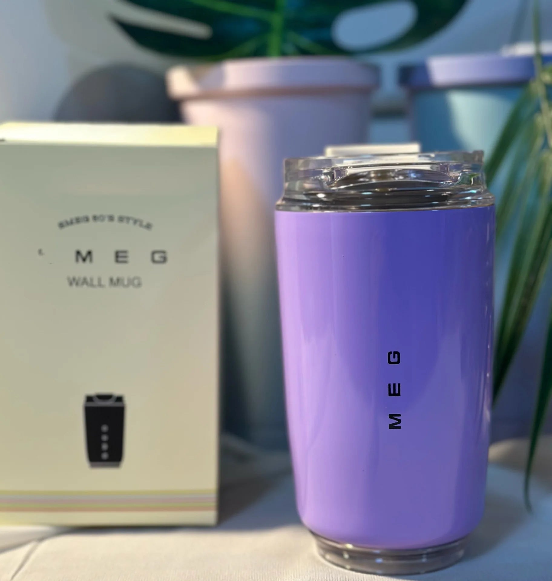 SMEG Purple mug with 'SMEG' branding next to a matching wall mug packaging.