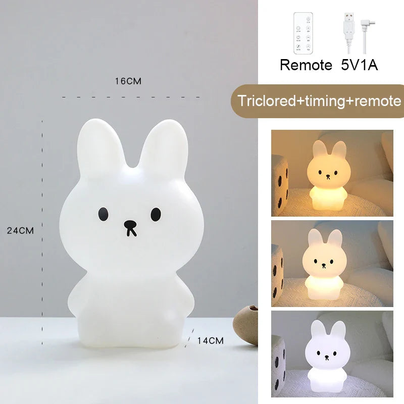 White rabbit-shaped night light with remote control and power adapter on a gray background