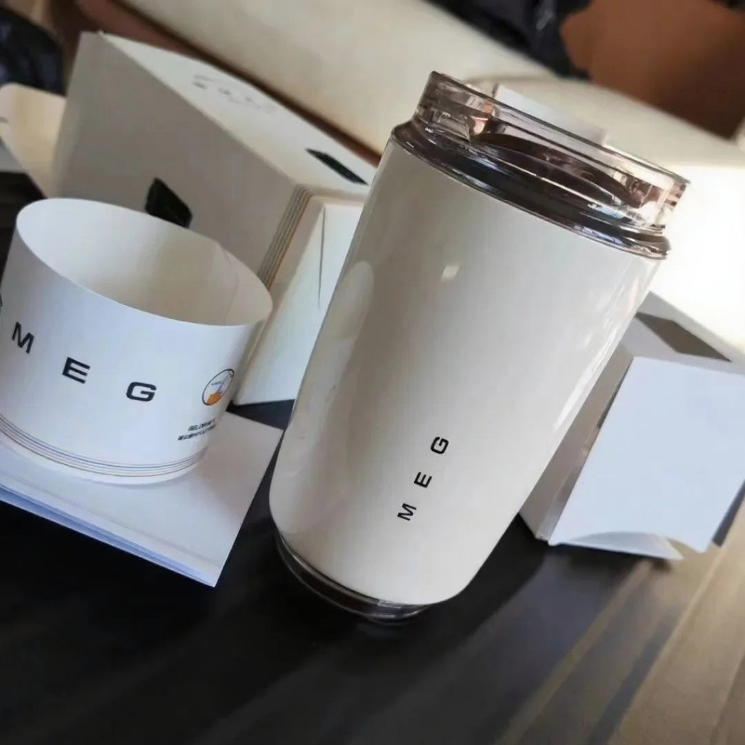 White tumbler with 'SMEG' branding on a dark surface
