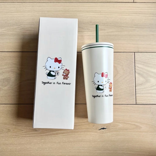 Hello Kitty Tumbler with cartoon character design next to a white box on a wooden surface